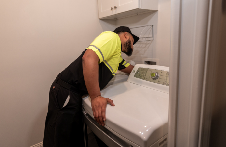 delivery man installing washing machine