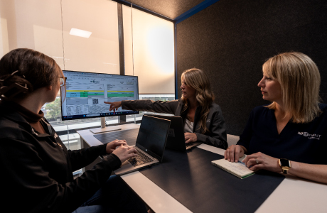 team members reviewing data on screen