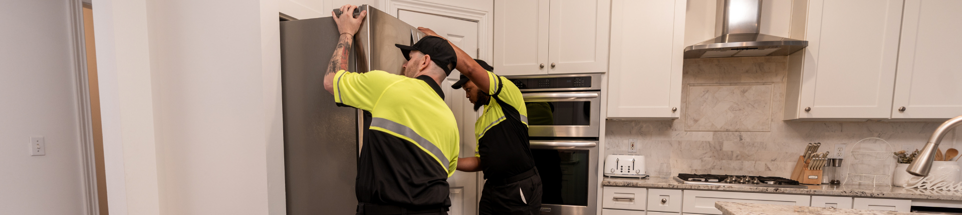 delivery crew placing refrigerator