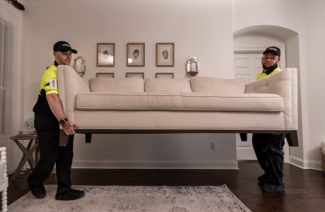 delivery team placing sofa in home