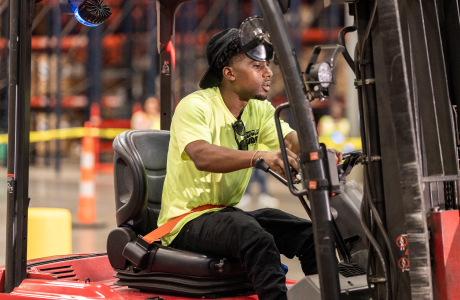 warehouse worker driving forklift